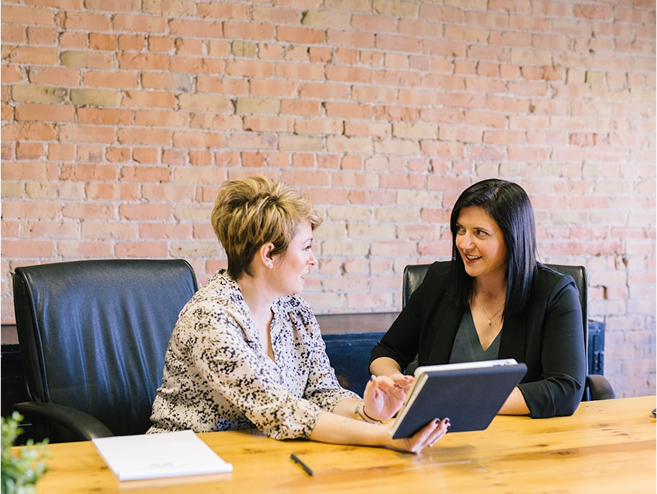 2 women are having an interview at a table